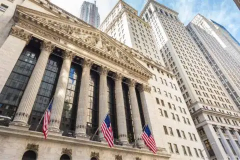 Modern financial district with tall skyscrapers and historic architecture.