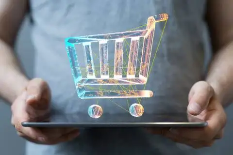 Digital shopping cart hologram representing energy and utility services on a tablet.