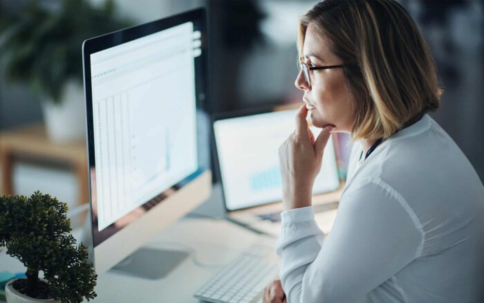 Side view of woman looking focused on computer screen