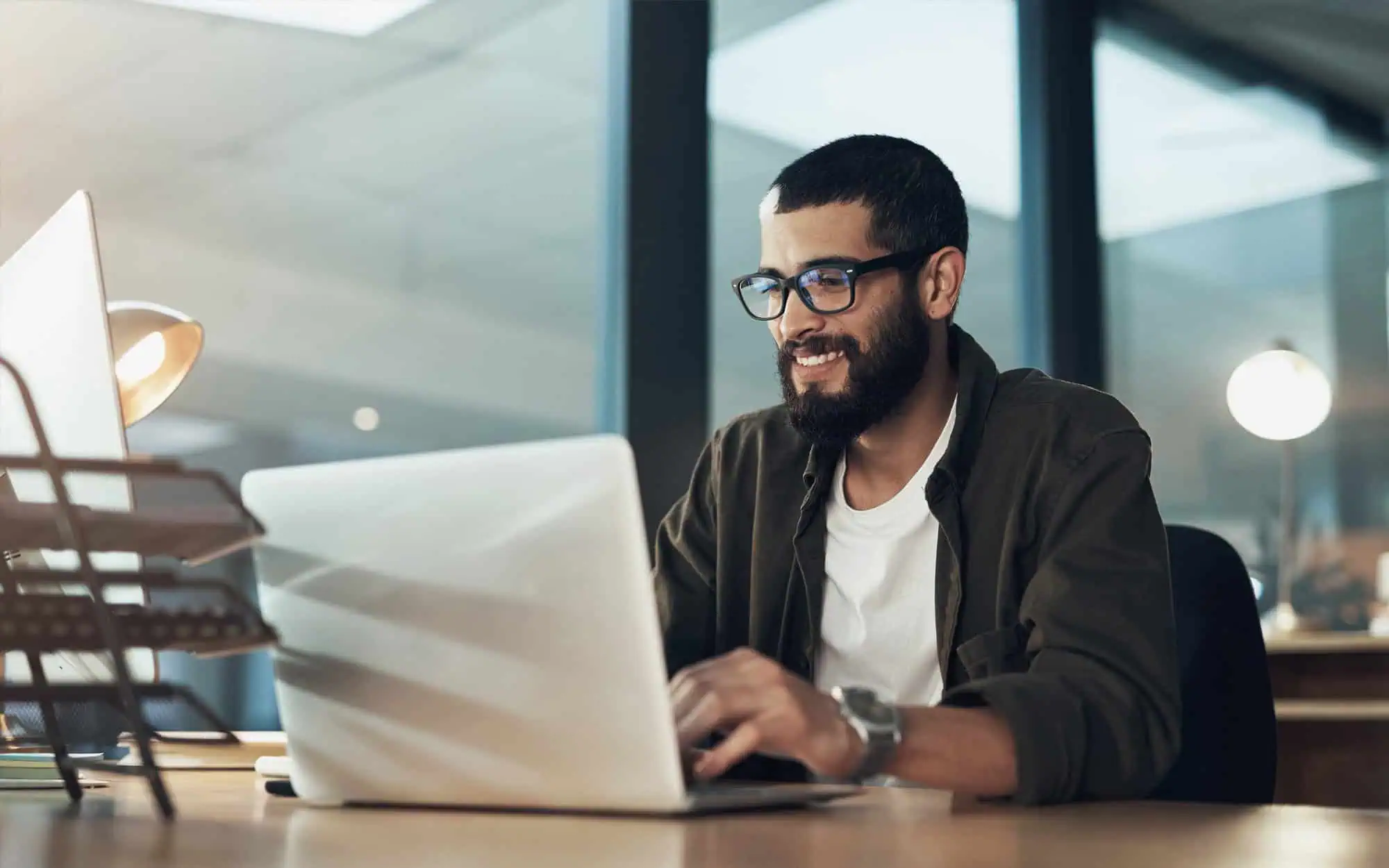 Efficient Software Scalability Solutions | i3solutions Business professional working on a laptop to overcome software scalability challenges.