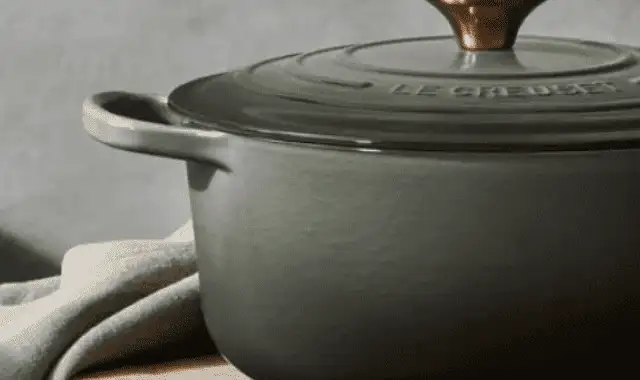 Cooking pot on wooden surface with cloth, minimalistic kitchen scene. Cooking pot on wooden surface with cloth, minimalistic kitchen scene.
