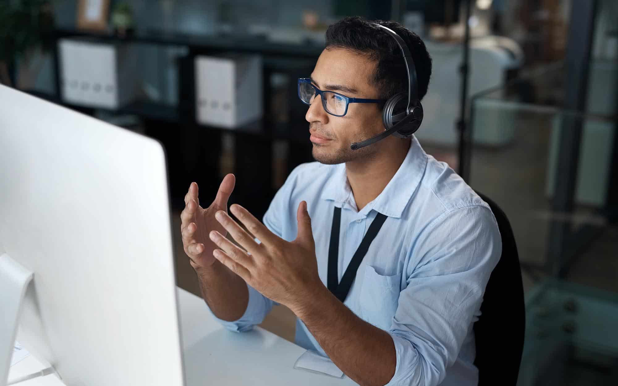 IT Staff Augmentation Expert | i3solutions Business professional discussing IT staff augmentation strategies at a computer.