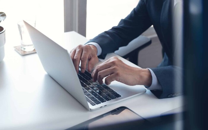 Business man working on laptop computer at modern office