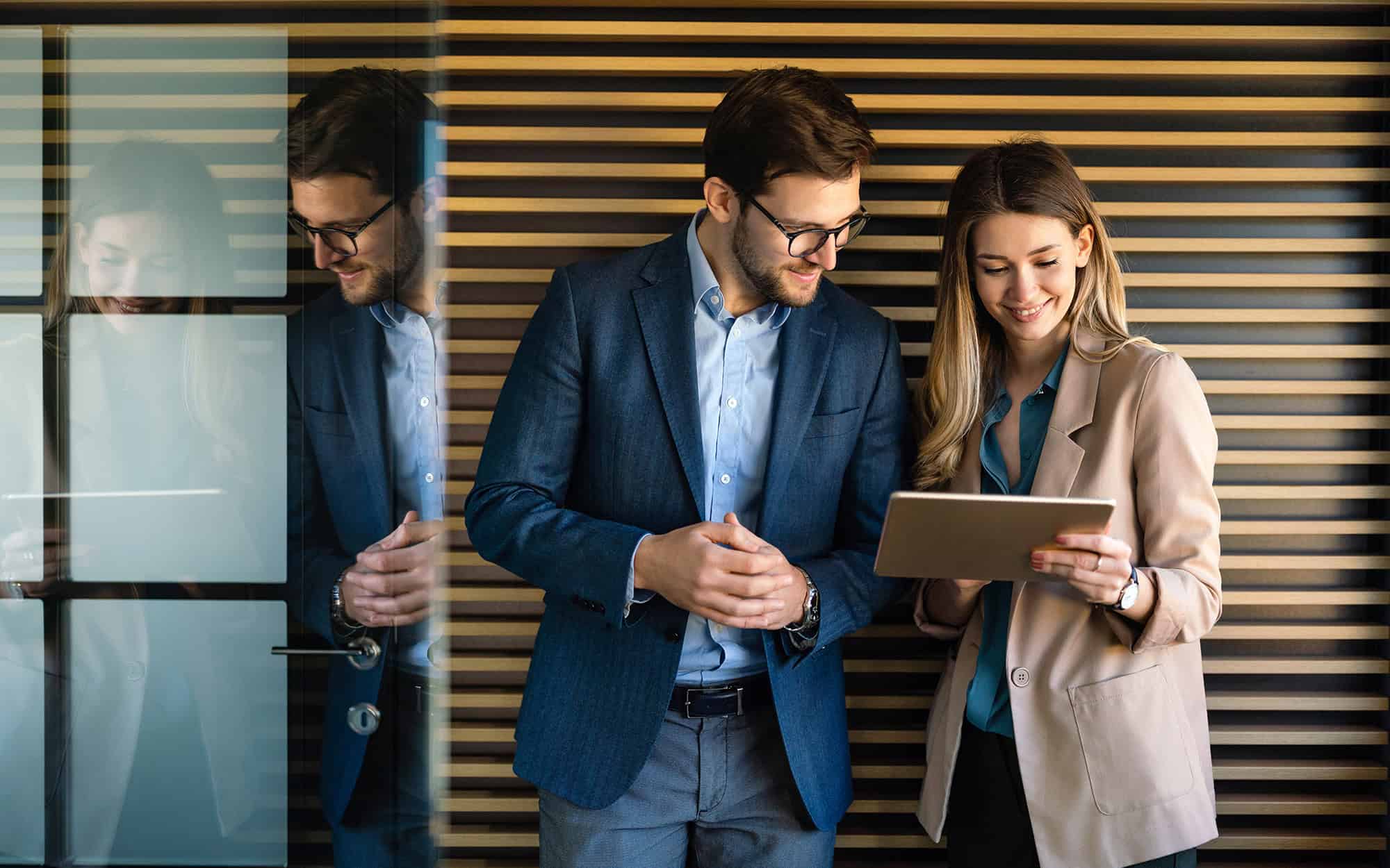 Technology Assessment for IT Environments | i3solutions Business professionals reviewing technology assessment report in modern office.