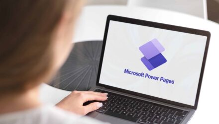 Person using a laptop displaying Microsoft Power Pages logo for website development.