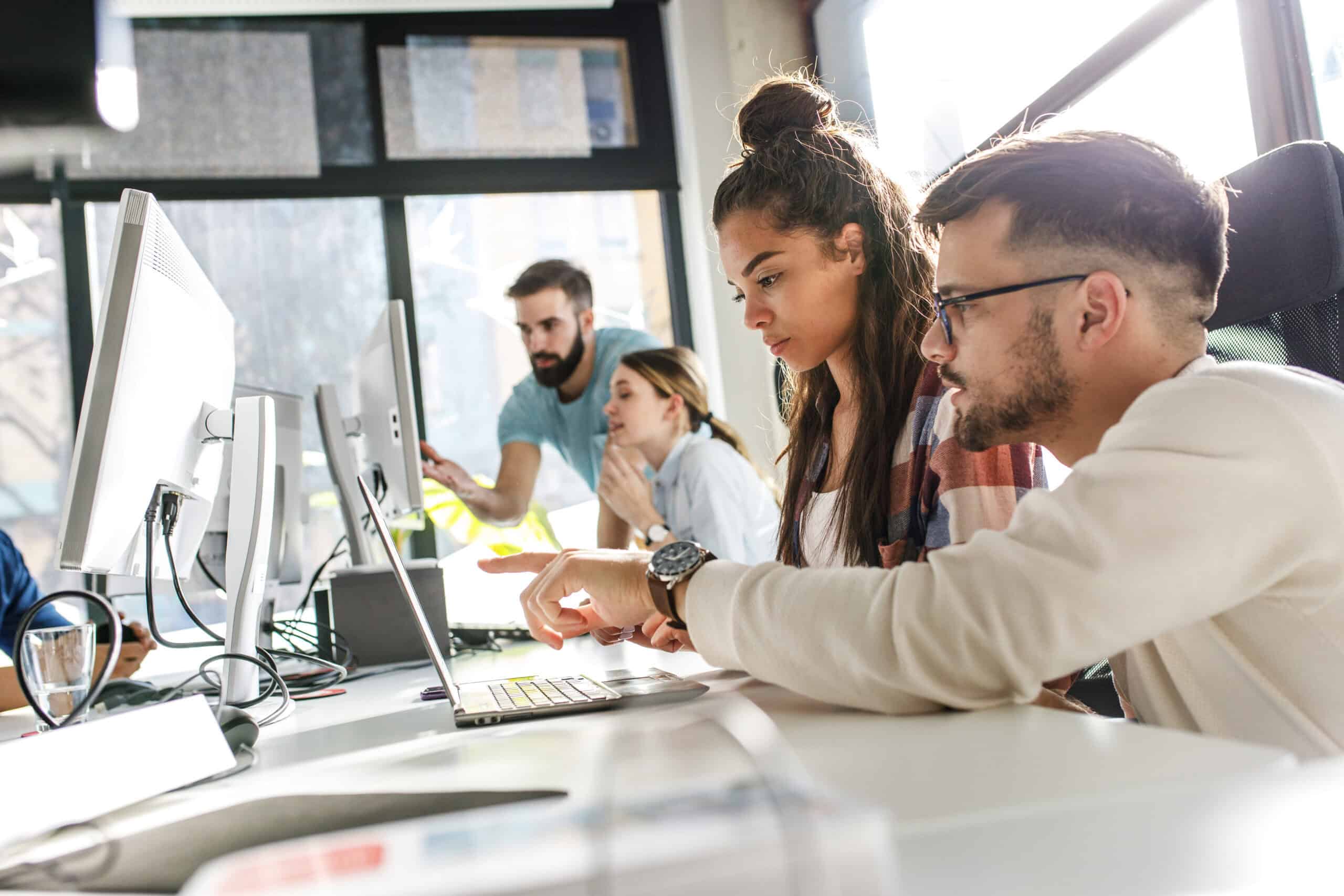IT Staff Augmentation Team | i3solutions Diverse IT team collaborating in an office for staff augmentation solutions.