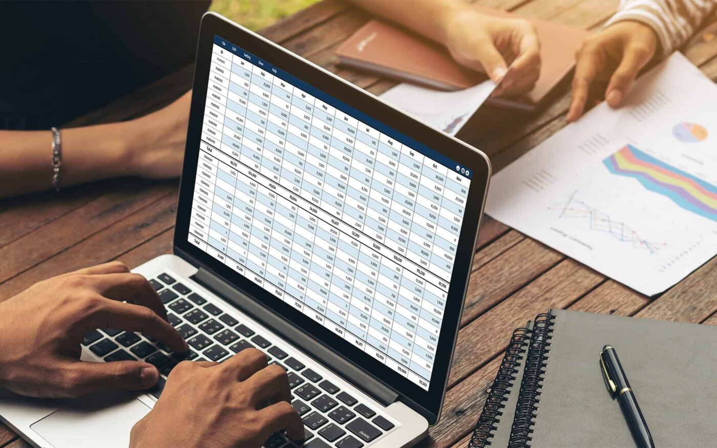 Person in office using spreadshee on latpop