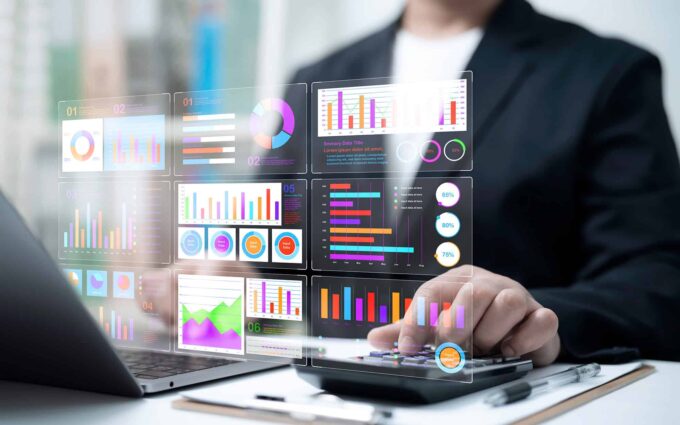 person looking at charts on laptop