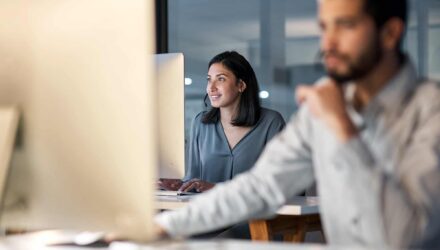 Modern Office Team Collaborating on Microsoft 365 Security | i3solutions Team working on Microsoft 365 security standards in a modern office setting.