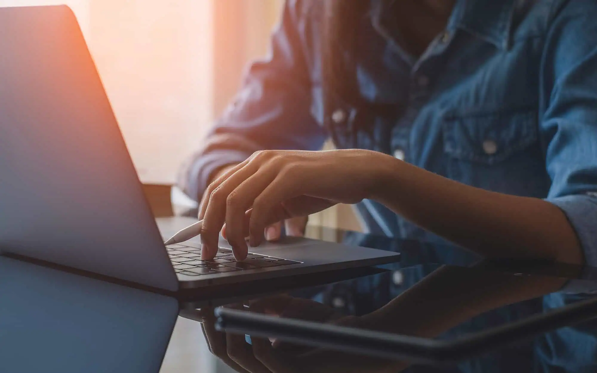 Streamlined SharePoint Content Management | i3solutions Person managing SharePoint content on laptop for organized information control.