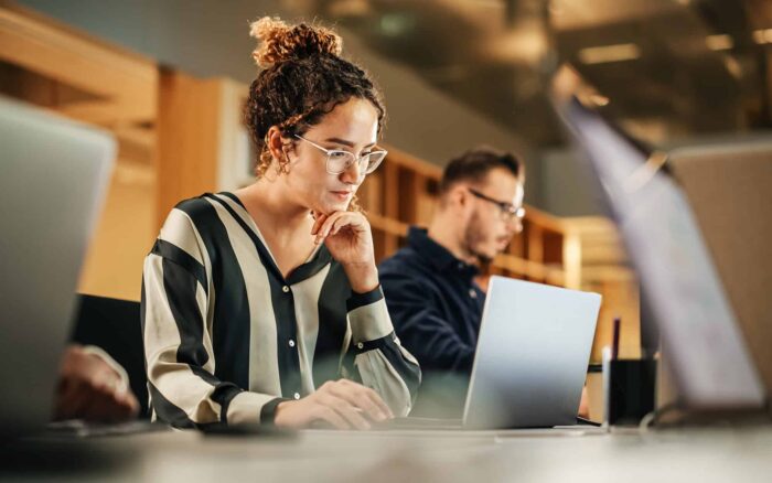 Young Woman Working on Computer in a Modern Bright Office