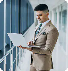 Business Professional Using Laptop in Office Enterprise leader reviewing automation and integration performance metrics to improve operational efficiency.