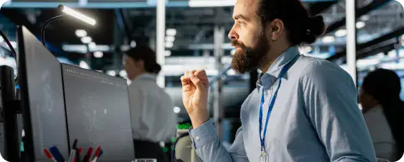 IT Professional Working at Data Center | i3solutions Engineer monitoring enterprise identity security systems on workstation.