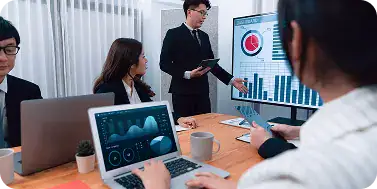 Business Meeting with Data Presentation | i3solutions Enterprise team reviewing performance dashboards during Microsoft implementation rollout.