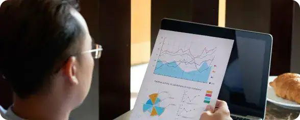 Businesswoman Analyzing Data Charts | i3solutions Executive reviewing AI-generated analytics and business intelligence powered by Microsoft Copilot.