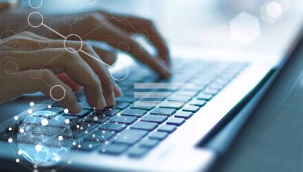 Innovative Tech Solutions | i3solutions Hands typing on a laptop keyboard with digital network graphics overlay.