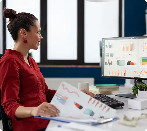 Businesswoman Analyzing Data on Computer | i3solutions Analyst reviewing enterprise analytics dashboards and reports, supporting decision-ready visibility across the organization.