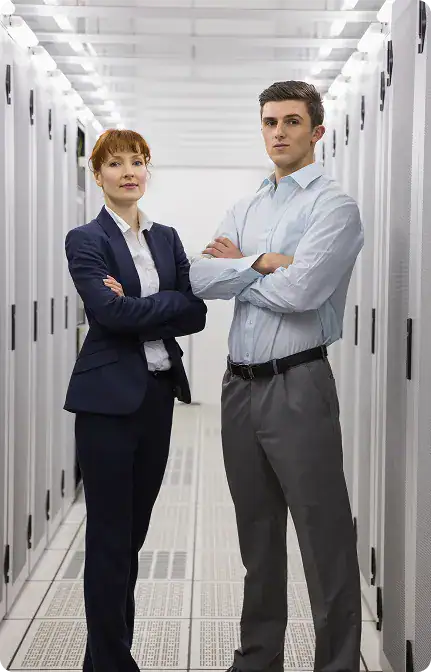 IT professionals in data center corridor | i3solutions Governed modernization approach that reduces delivery risk through visibility, phased execution, and embedded security and compliance.