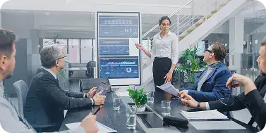 Business Meeting with Data Presentation | i3solutions Enterprise team monitoring device compliance and conditional access enforcement in Microsoft Intune.