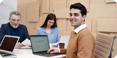 Professional Business Meeting with Laptops | i3solutions IT team planning Intune enrollment strategy across corporate and BYOD devices.