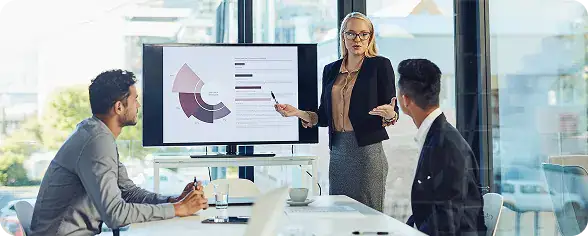 Business Presentation at Modern Office | i3solutions Enterprise team reviewing AI-powered analytics and predictive insights using Microsoft Fabric dashboards and reporting tools.