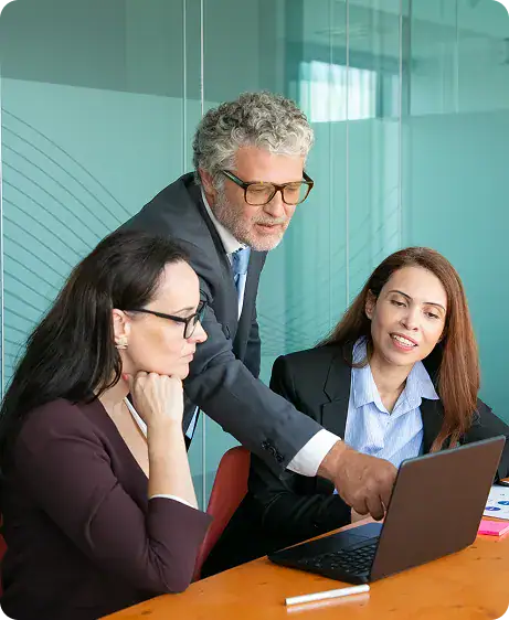Business Meeting with Laptop and Team | i3solutions Enterprise leaders reviewing Microsoft Fabric analytics insights and unified data dashboards for strategic decisions.