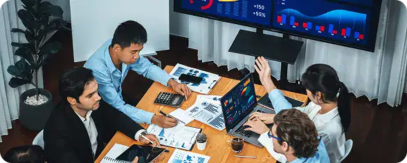 Business Meeting with Data Analysis | i3solutions Team monitoring unified system performance after eliminating manual data transfers and redundant workflows through integration.