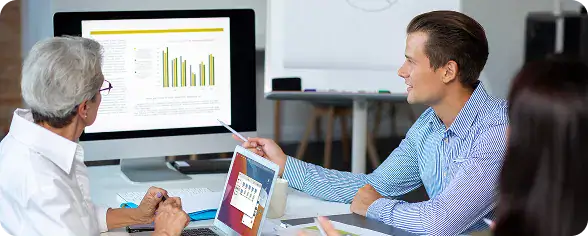 Business Meeting Discussing Data Analysis | i3solutions Executives reviewing Microsoft Fabric real-time analytics dashboard with performance metrics and data visualizations.