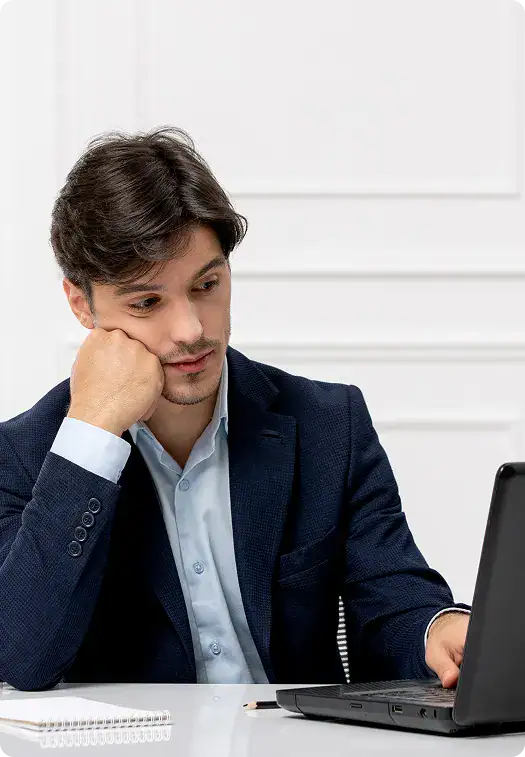 Businessman Analyzing Data on Laptop | i3solutions IT leader frustrated by ungoverned Microsoft platform sprawl, permission chaos, and accumulating compliance risk.