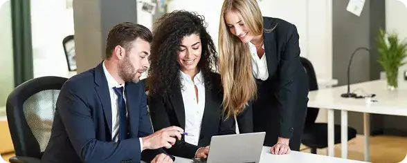 Business Team Collaborating on Laptop | i3solutions Enterprise stakeholders aligning Microsoft governance decisions to control risk and manage change across the Microsoft stack.