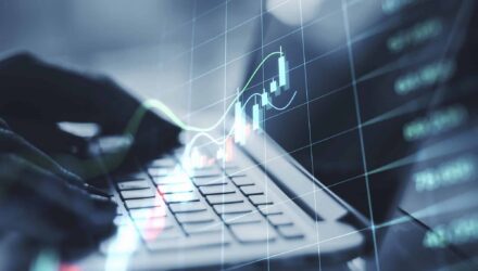 Business analytics and data visualization on a laptop with digital graphs.
