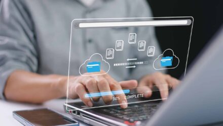 Cloud Data Migration for SharePoint | i3solutions Business professional managing cloud data transfer on a transparent digital screen.