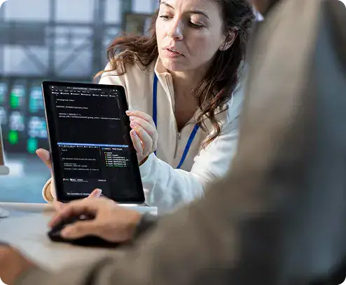 Software Developer Reviewing Code on Tablet | i3solutions Enterprise developer analyzing custom application architecture to align software with business workflows and scalability requirements