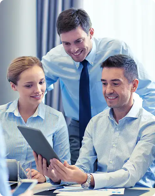 Team Collaborating on Digital Device | i3solutions Enterprise leaders reviewing workflow automation use cases across workforce, financial, and compliance operations