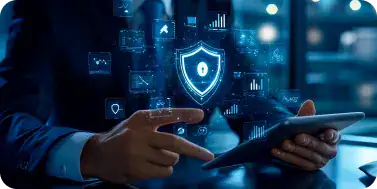 Cybersecurity and Data Protection Concept | i3solutions Businessperson using a tablet with a glowing security shield and floating digital icons, symbolizing cybersecurity protection.