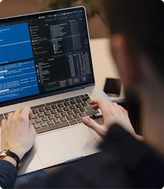 Power Platform Developer Working on Laptop | i3solutions Power Platform developer working in a governed enterprise development environment