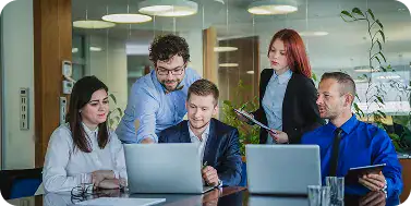 Business Team Collaborating on Laptop | i3solutions Enterprise team configuring role-based access control policies during a governance review session