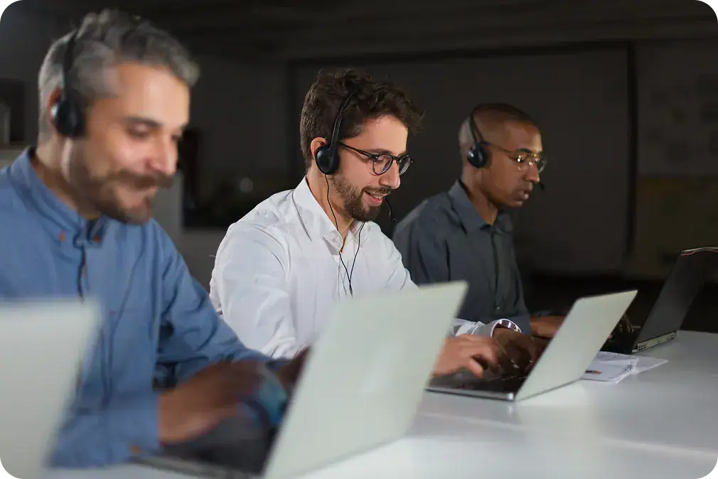 Post-Implementation Support Team | i3solutions IT support team working on laptops during post-implementation phase.