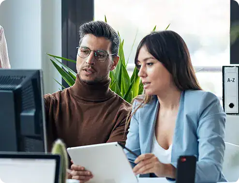 Business colleagues discussing data on tablet | i3solutions InfoPath migration services for Microsoft workflows, governed replacement architecture, and enterprise delivery risk.