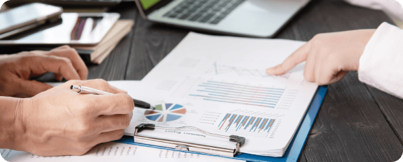 Business professionals reviewing data charts and graphs during a meeting.