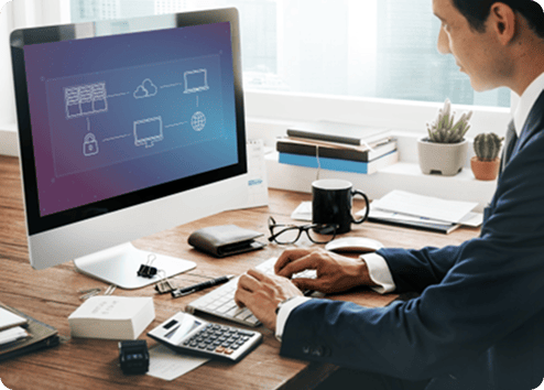 Business professional working on cloud migration on desktop computer.