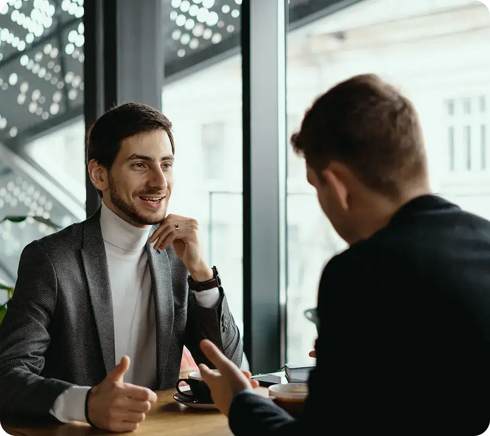 Post-Implementation Support Meeting | i3solutions Business professionals discussing support strategies in a modern office.