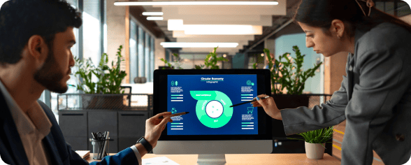Two professionals analyzing data on a computer screen in a modern office.