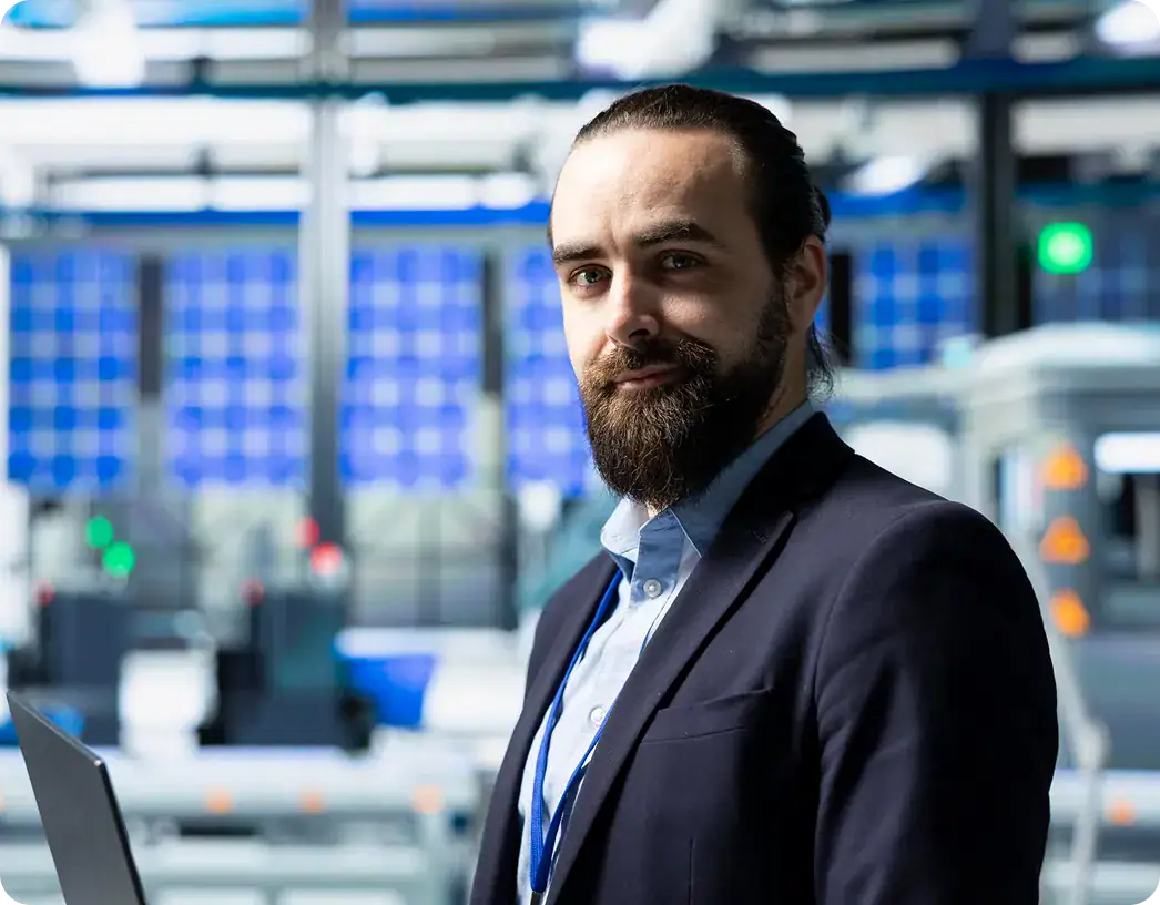 Professional in Data Center Environment | i3solutions Business professional in data center with servers and technology equipment.
