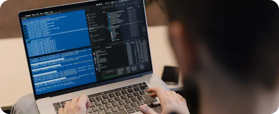IT Software Testing and Analysis | i3solutions Person analyzing software code on a laptop for IV&V services.