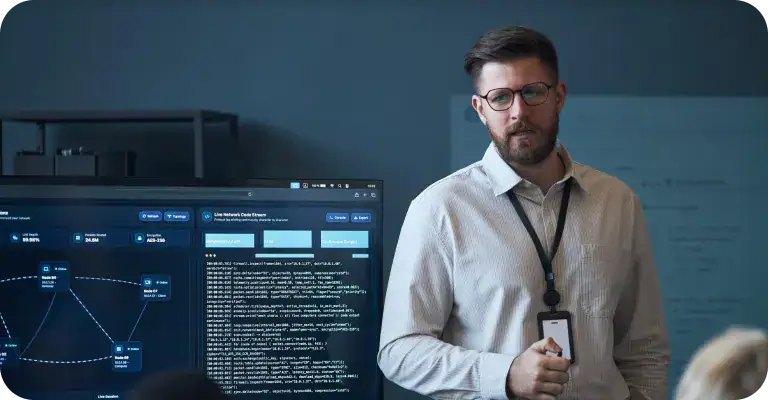 Professional presenting data analysis | i3solutions Man presenting data analysis on a large screen in a modern office.