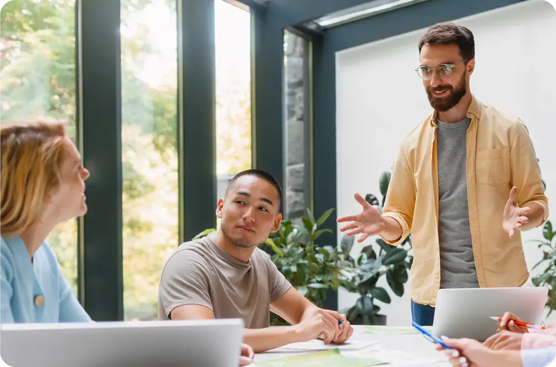 Business team discussing IT systems analysis in a modern office setting.