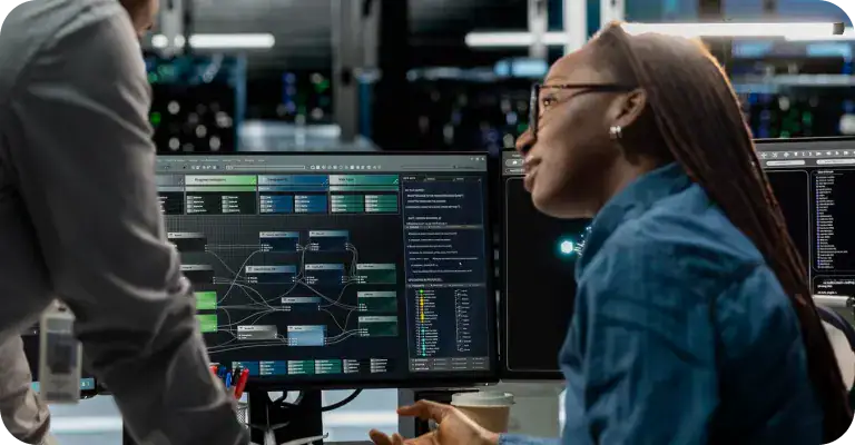 AI Data Analysis in Tech Lab | i3solutions Woman analyzing data on multiple computer screens in a high-tech lab.