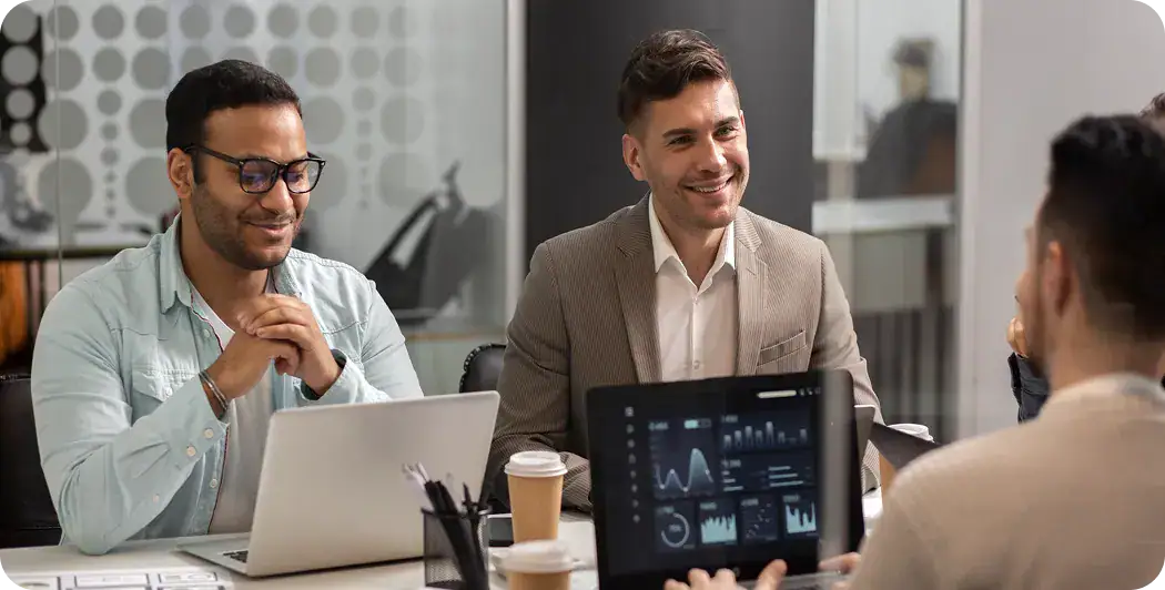 Business Meeting Discussing Data Analytics | i3solutions Business professionals analyzing data on digital devices in a modern office.