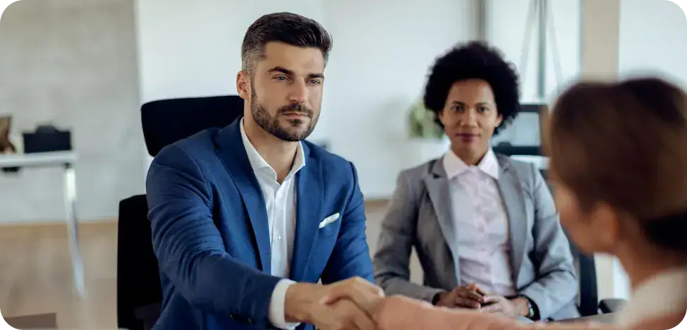 Business Meeting with Professionals Business professionals shaking hands in a corporate meeting.